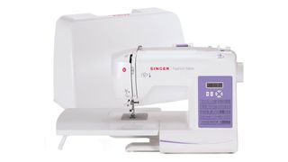 Best sewing machines for beginners; a small white sewing machine with a case