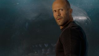 Jonas (Jason Statham) with the megalodon behind him in a scene from "The Meg"