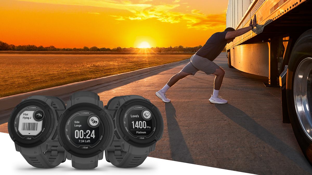 Man stretching beside truck wearing Garmin Instinct 2 Dezl Edition watch