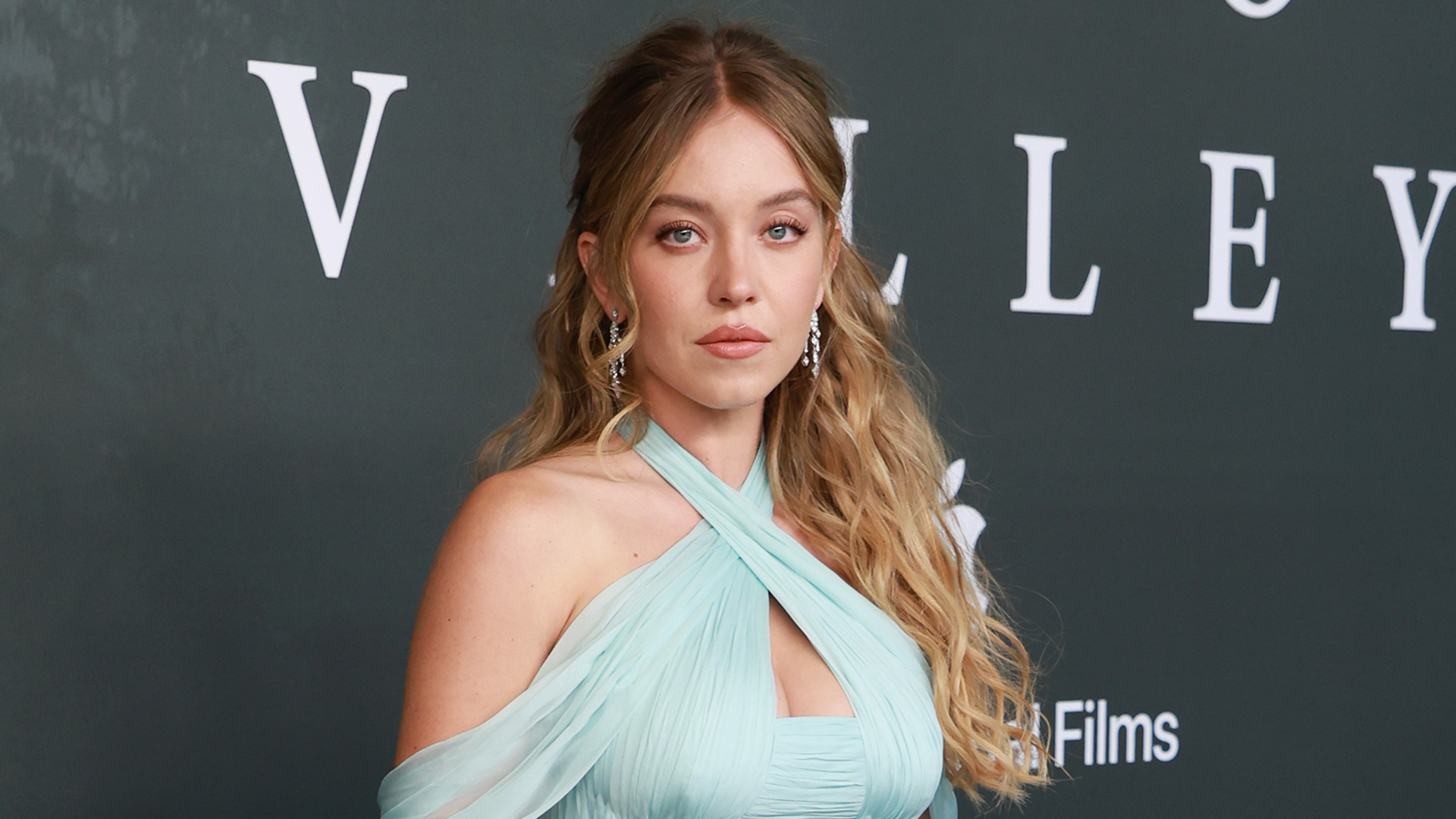 Sydney Sweeney attends the 'Echo Valley' premiere in a blue Miu Miu gown.