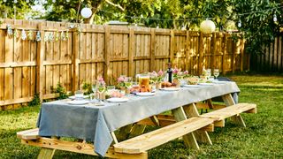 garden party idea for dressing picnic benches with linen tablecloths