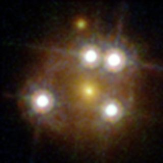 This Hubble Space Telescope view shows a close-up of the distant quasar WFI2033-4723, which is one of the five best lensed quasars ever seen. The quasar appears as four bright objects in a cosmic lens around a central galaxy that is actually in the foregr