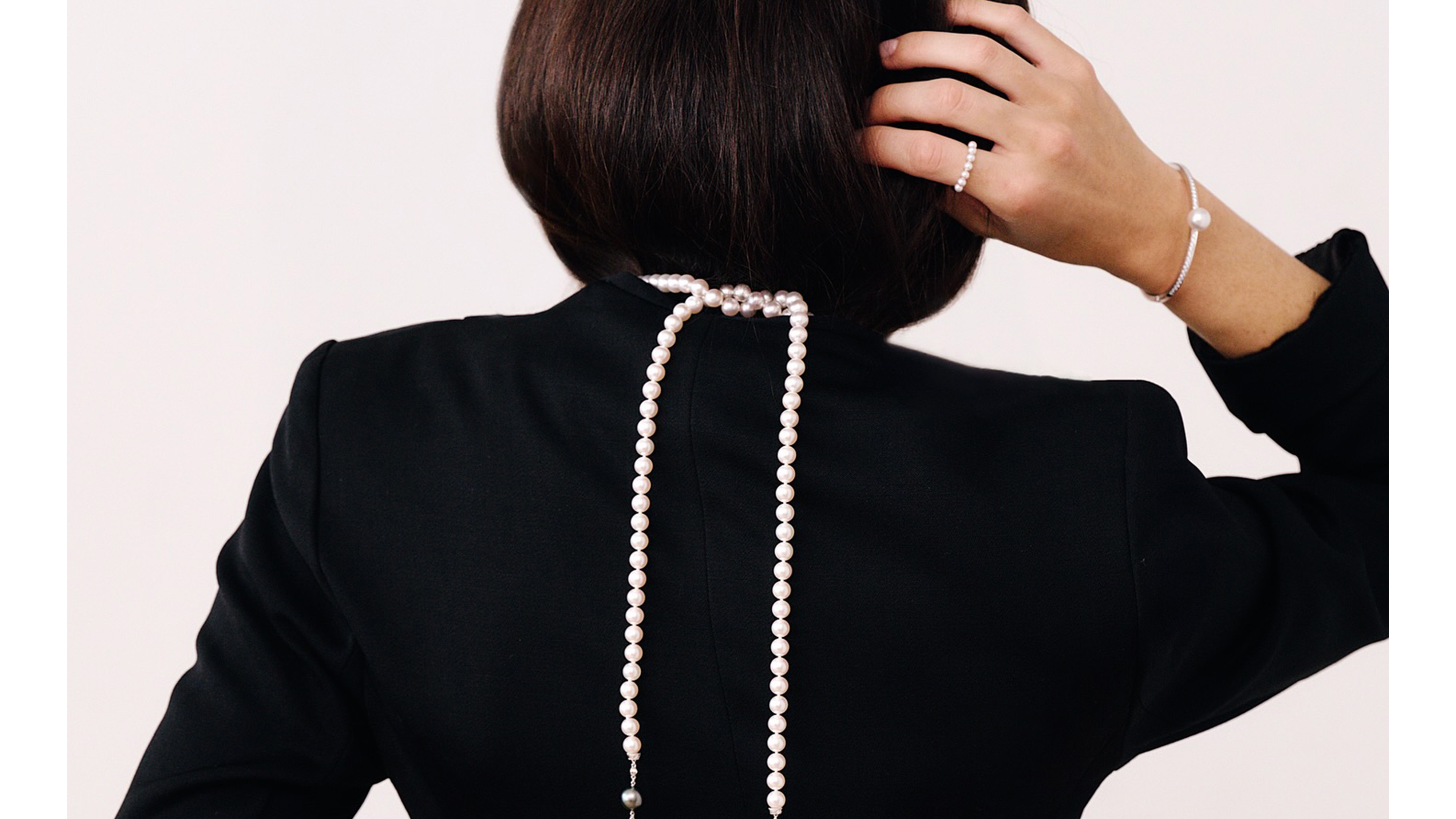 Woman wearing Mikimoto jewelry.