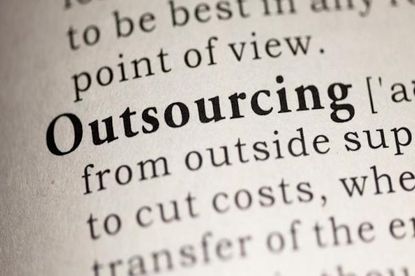 The word 'outsourcing' in bold on piece of paper