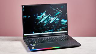 Acer Predator Helios 18 AI open on desk with pink background