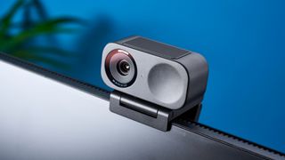 A black Insta360 Link 2C webcam with a magnetic L-shaped mount