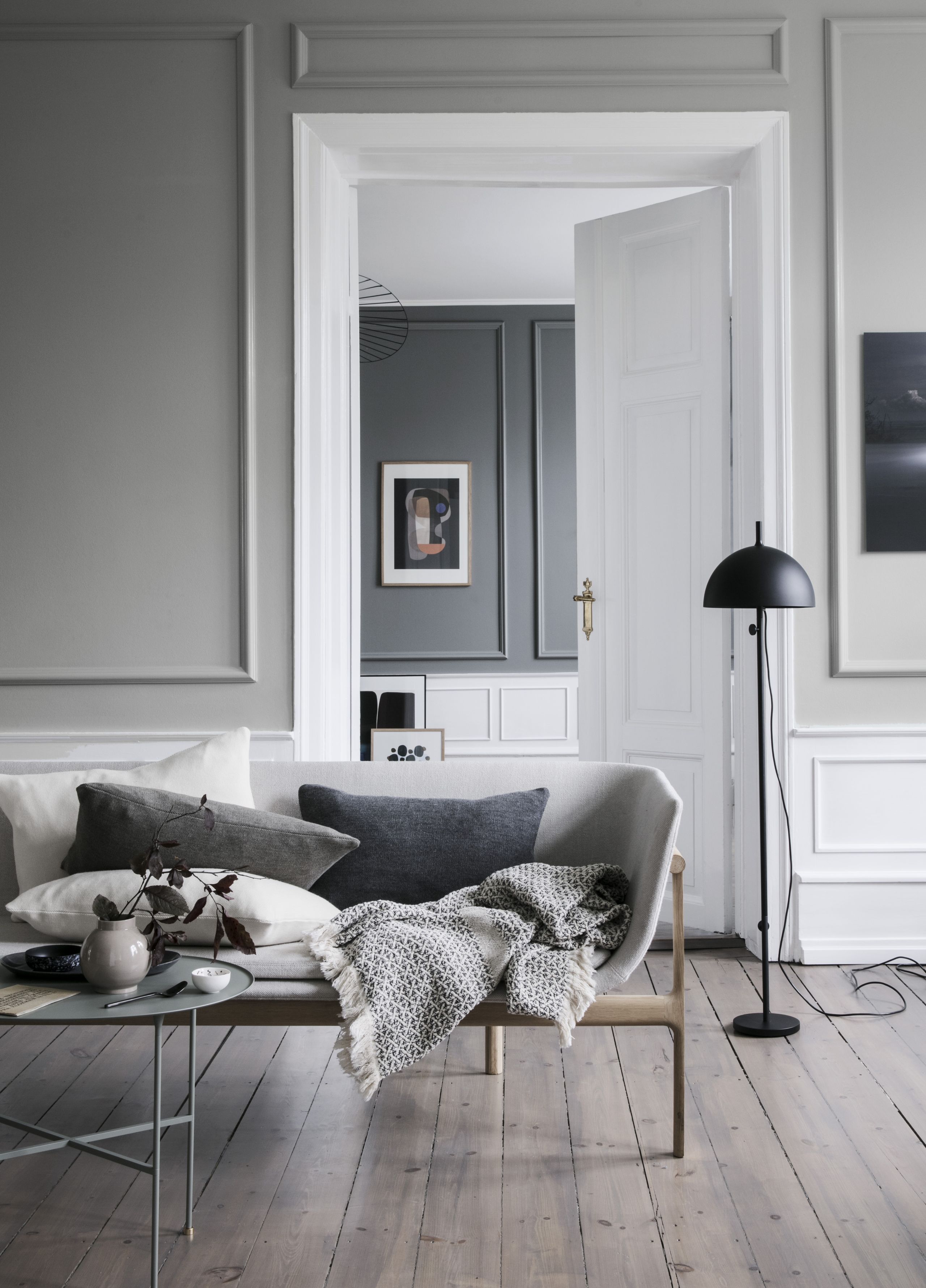 Grey living room with grey walls, grey cushions and grey throw