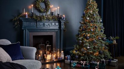 dark blue themed christmas decor with tree, wreath and fireplace