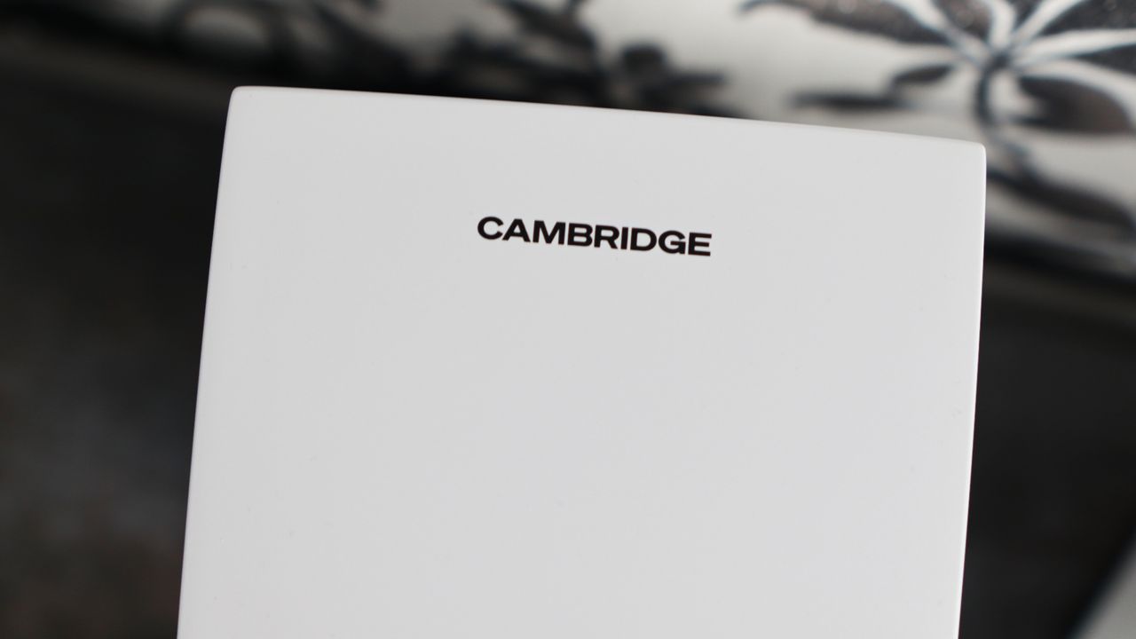 Cambridge Audio's L/R S speakers on a desk. The speakers are white with black tweeters.