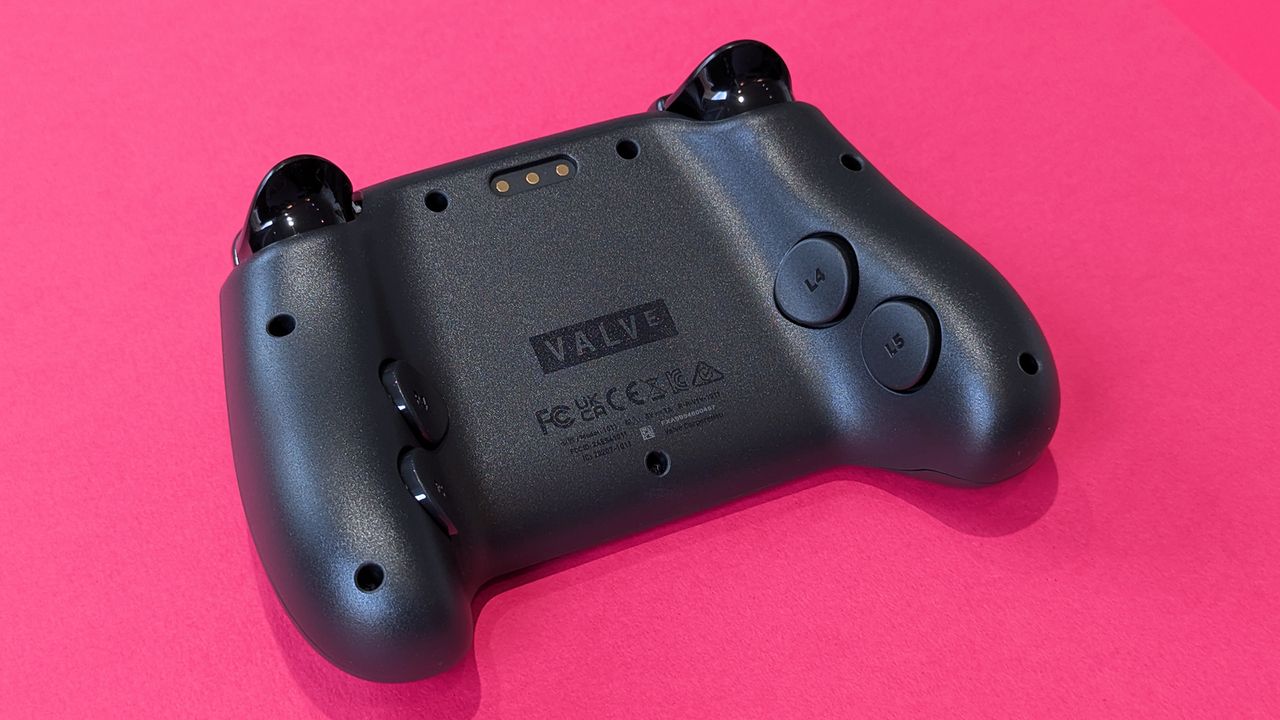 Rear view of the Valve Steam Controller (2026), highlighting buttons, against a magenta card background