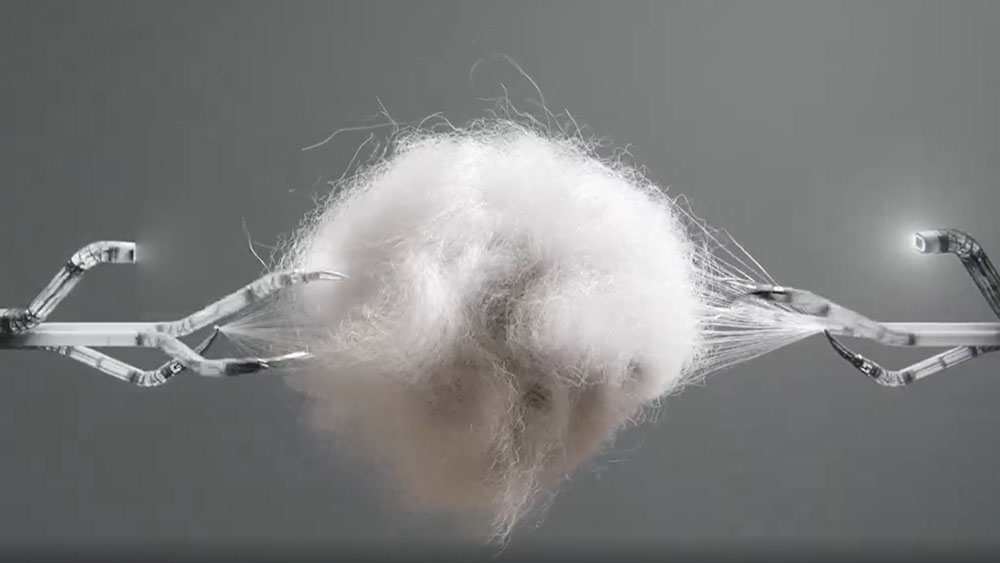 Image of cotton being worked by robot arms from a 3D animation and fabric simulation