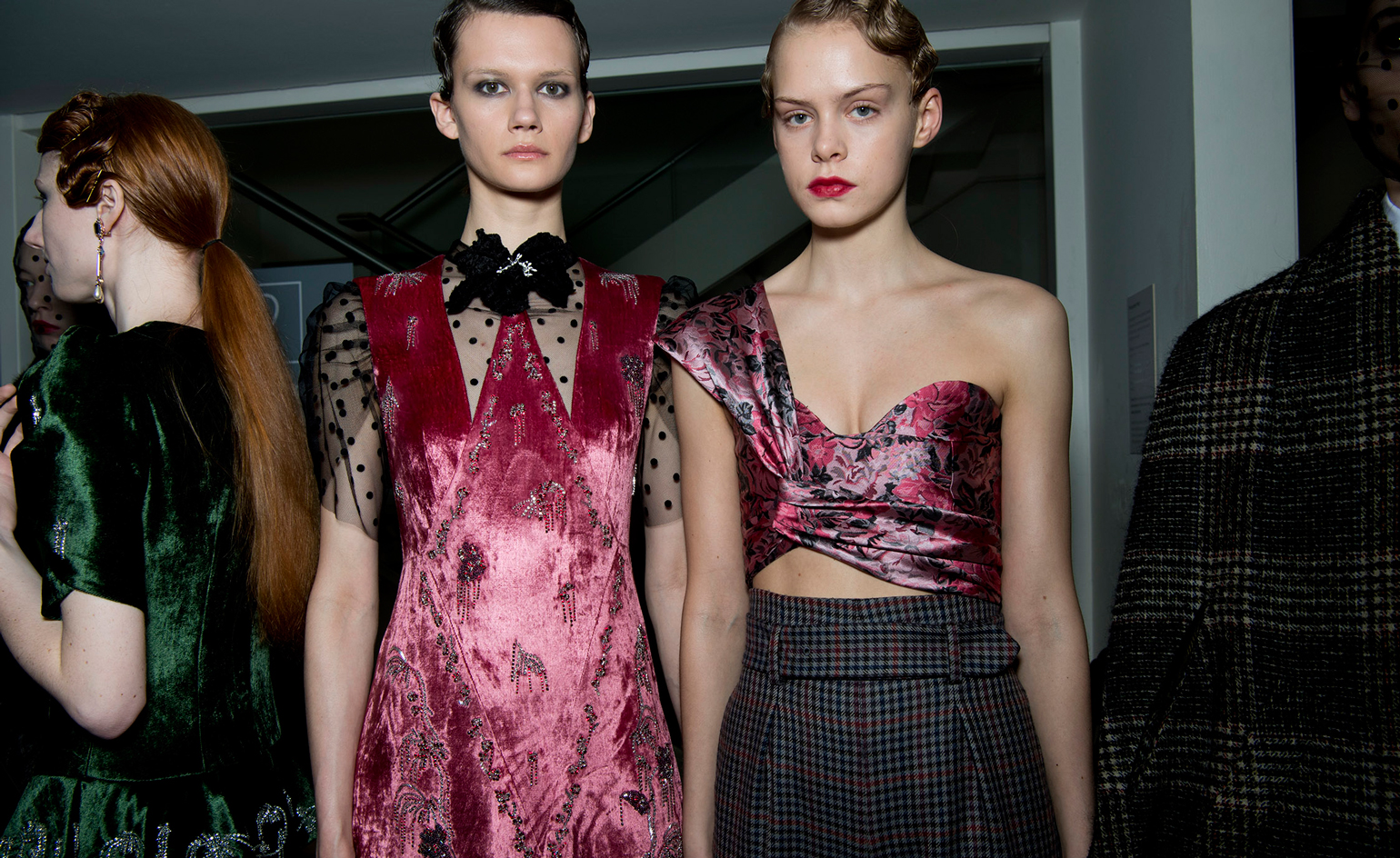 Model is seen wearing a pink velvet sleeveless dress, with a mesh t-shirt underneath. Another wears a floral wrap crop top