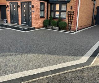 modern dark resin driveway with border