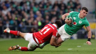 Ireland's wing Calvin Nash (R) is tackled by Wales' wing Rio Dyer (L) during the Six Nations international rugby union match between Ireland and Wales at the Aviva Stadium in Dublin, on February 24, 2024