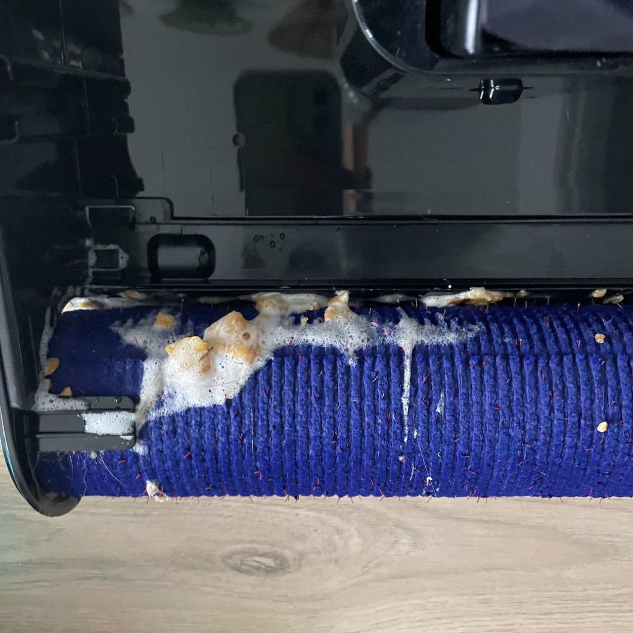 Close up of the Dyson Clean+Wash Hygiene dirty roller with debris all over it