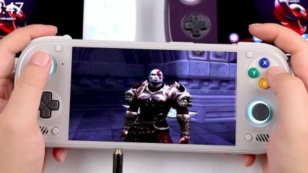 Hands holding Ayn Odin 3 handheld in white with Kratos from God of War on screen.