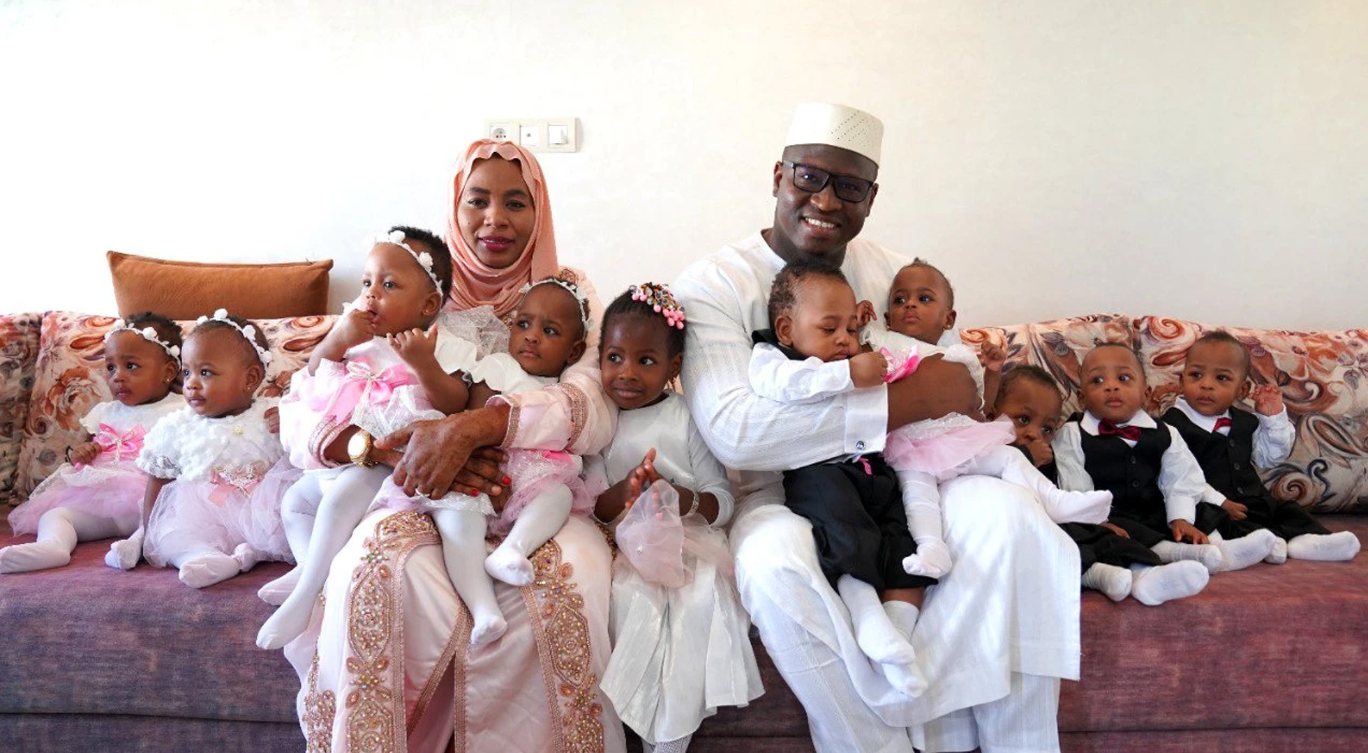 Halima Cisse and Abdelkader Arby proudly pose for a photo with their children on their 1st birthday