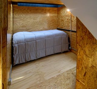 Each bedroom is treated as a 'cube', wooden structures that are clearly expressed as they poke through the original brick façade