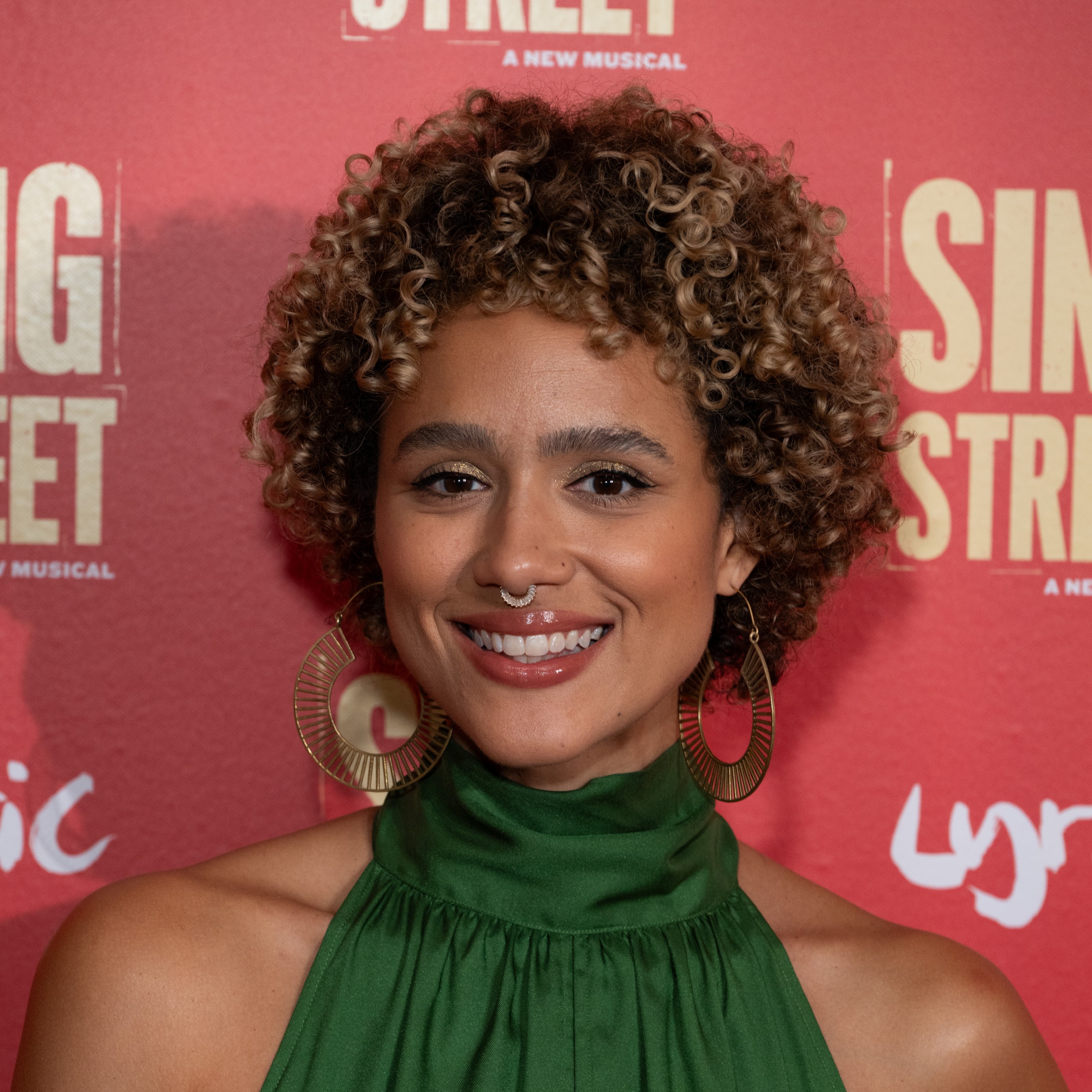 Nathalie Emmanuel posing with her hair highlighted.