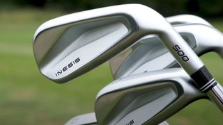 inesis 500 irons resting in a golf bag on the course