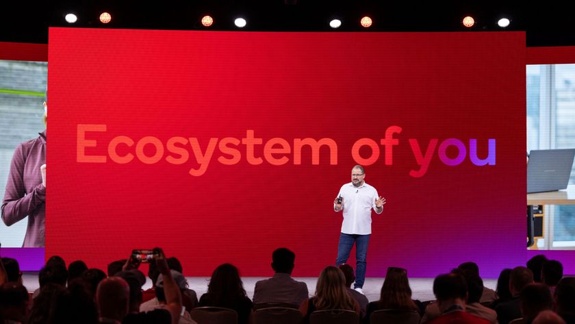 Cristiano Amon on stage with &quot;Ecosystem of you&quot; on a screen