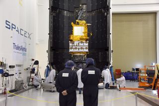 In the SpaceX Payload Processing Facility at Vandenberg Air Force Base in California, scientists and engineers encapsulate the Jason-3 satellite in its payload fairing ahead of its planned Jan. 17, 2016 launch.