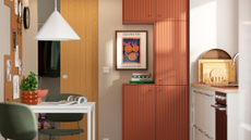 small modern kitchen with red, wave-pattern cabinet doors from IKEA