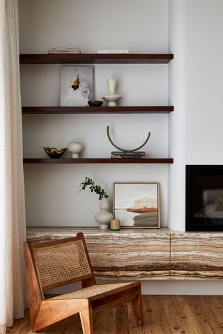 modern shelving in a living room with layered art work