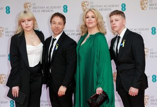 Hannah Walters and Stephen Graham pose with children Grace and Alfie at the EE British Academy Film Awards 2022 at Royal Albert Hall in London