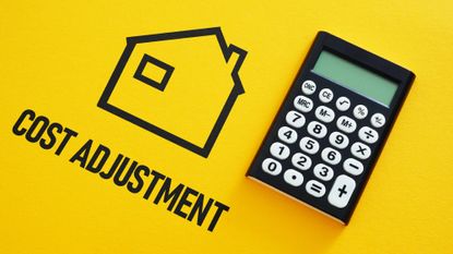 Calculator sitting on a yellow background next to the outline of a house and text that reads "cost adjustment"