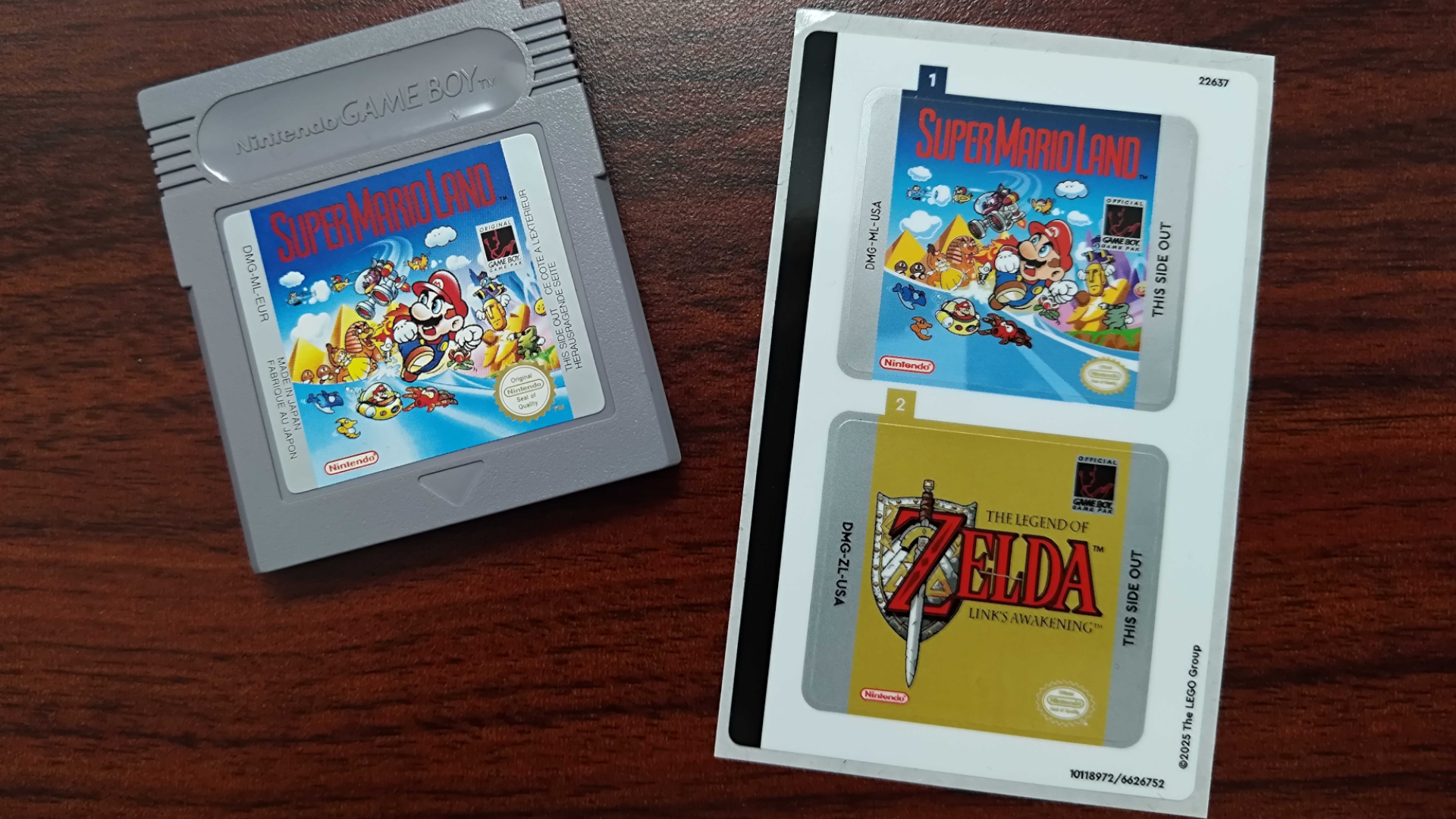 A retro Game Boy cartridge beside stickers for the Lego version