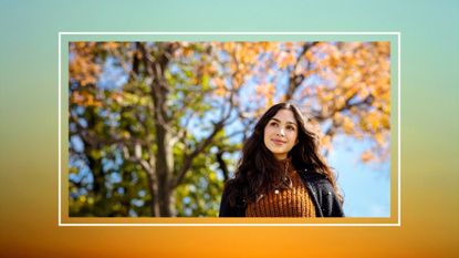 woman in sweater outside near changing leaves; autumnal equinox 2022 feature