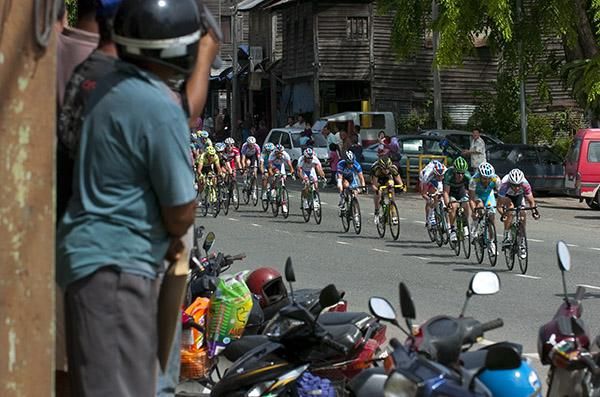 The peloton pass through a town on the 205 kilometres seventh stage from Bentong to Kuantan.