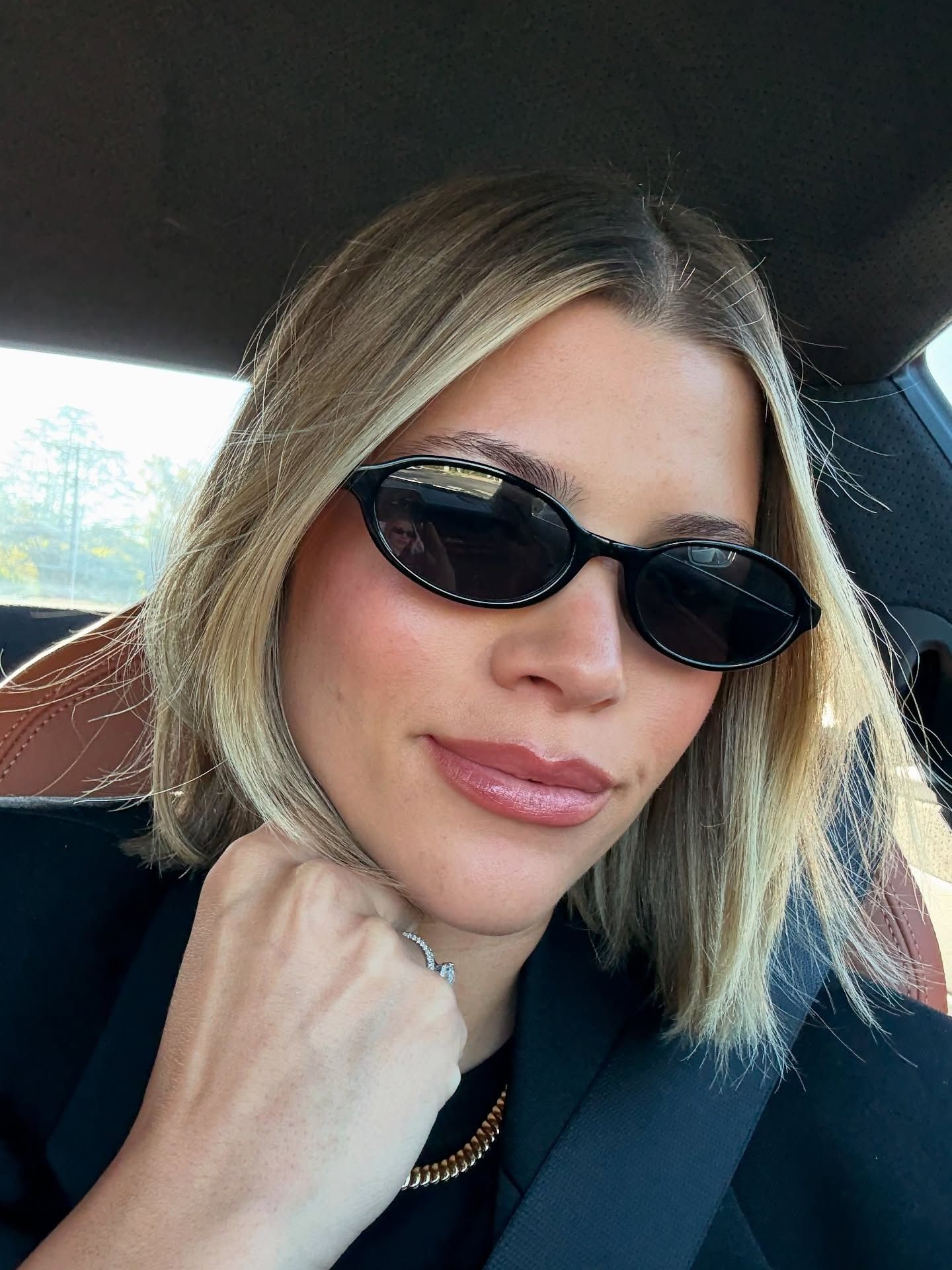 Sofia Richie Grainge wearing black sunglasses with a blonde straight blunt bob haircut