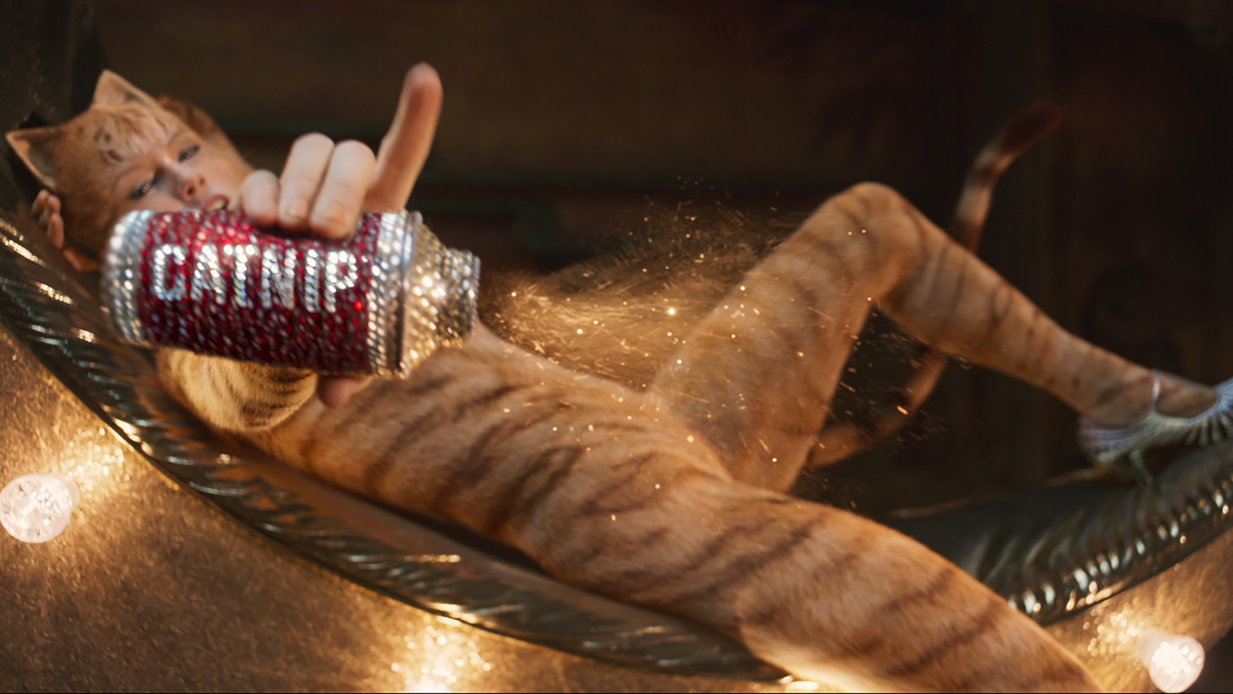 An anthropomorphic cat from the movie Cats holding a can of sparkly catnip