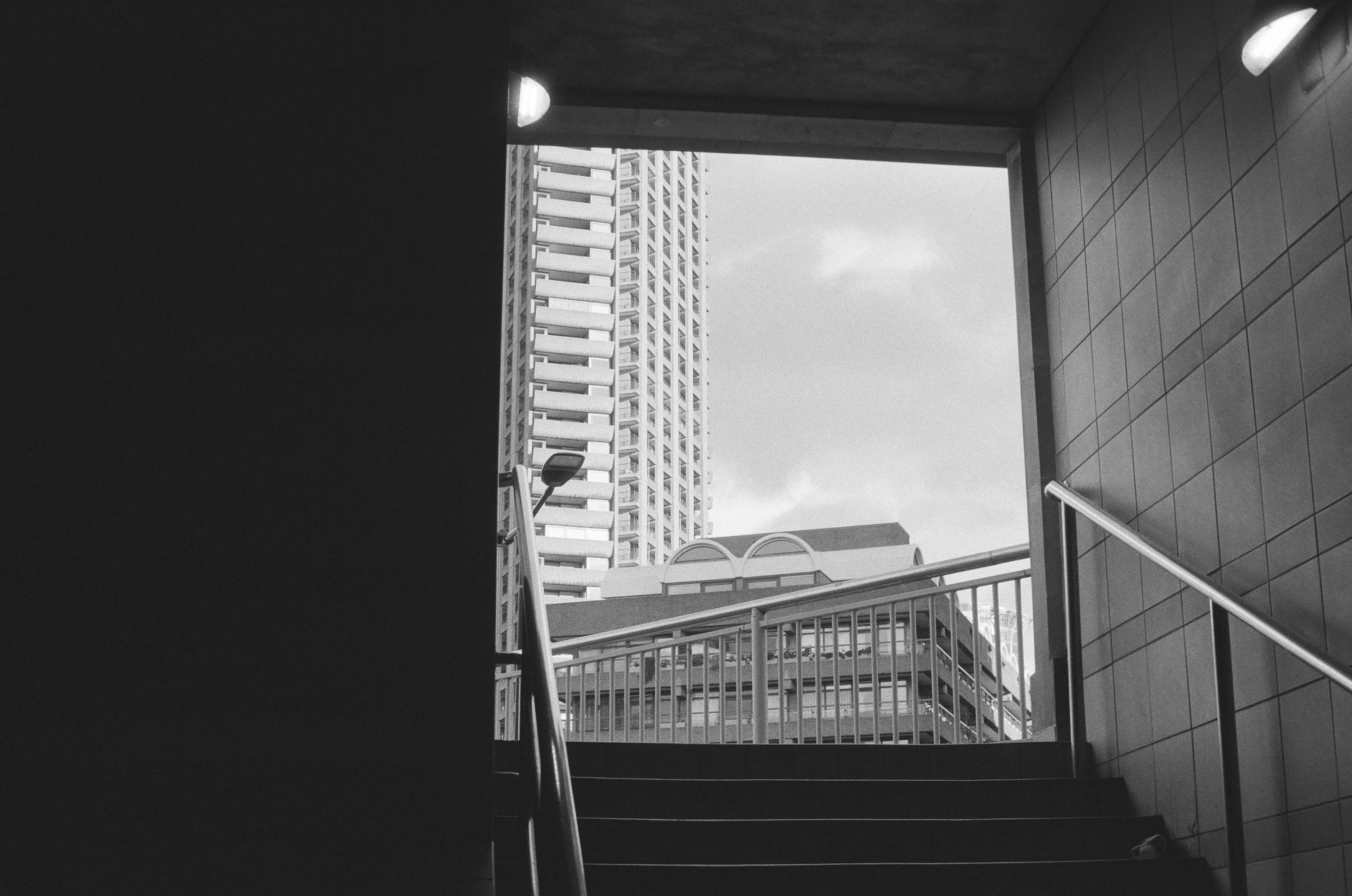 Sample photo of AgfaPhoto APX 400 35mm film showing high-contrast scene with London&#039;s Barbican visible brightly through an open doorway