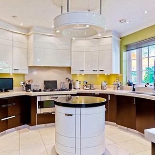 kitchen room with white ceiling lights and marble worktop
