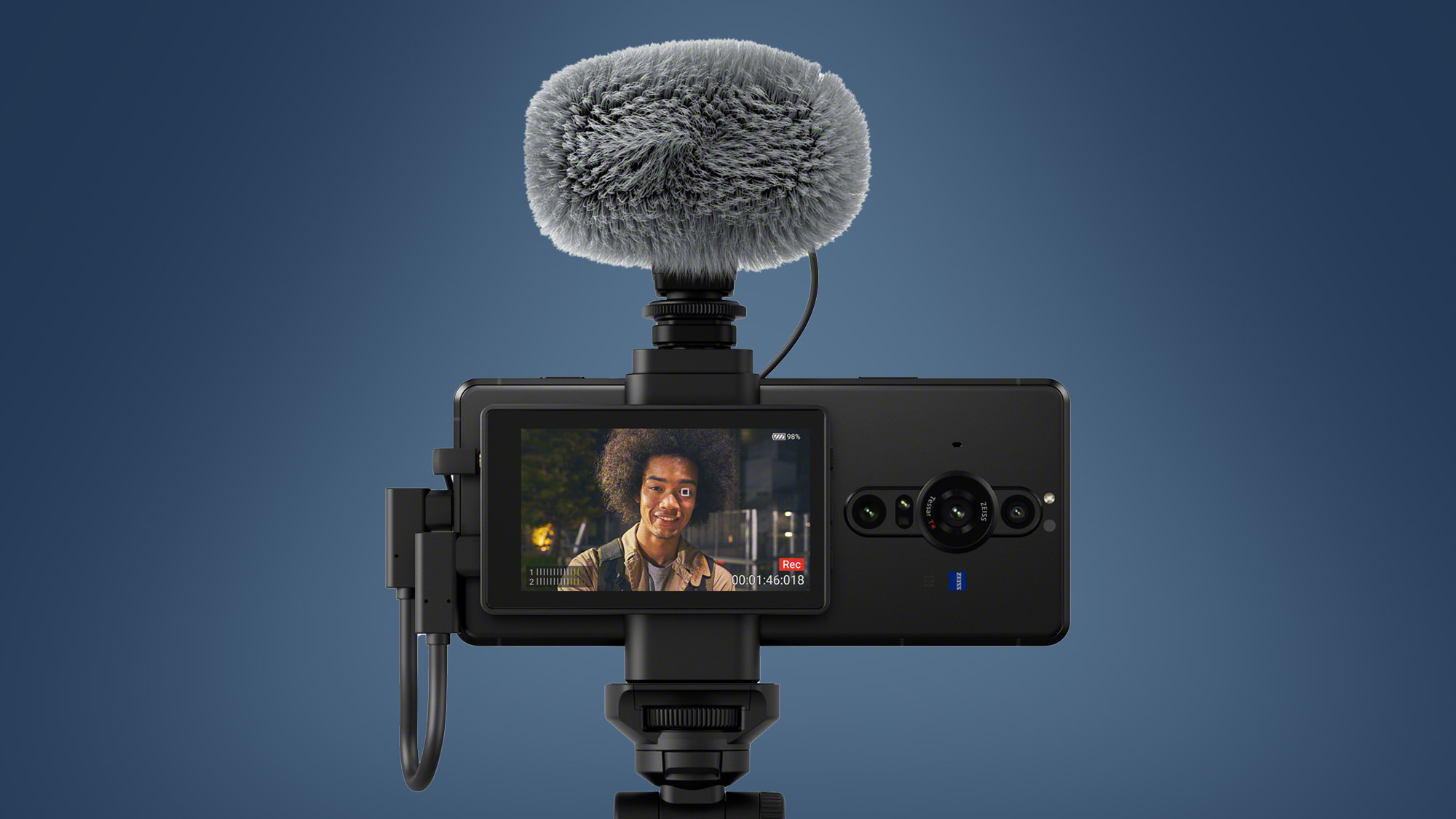 The Sony Xperia Pro-I phone with its Vlog Monitor accessory on a blue background