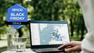 A laptop is open with pins showing across a map of Europe, on a table next to a glass of water with trees in the background and the Space.com logo in the top left corner.