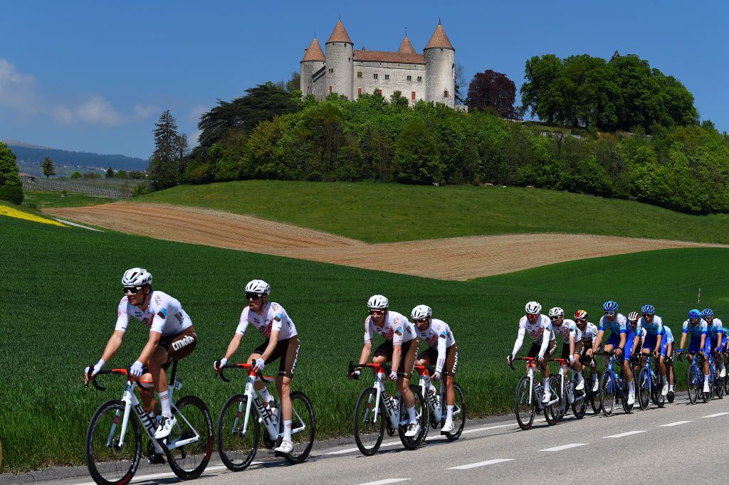 ROMONT SWITZERLAND APRIL 27 A general view of Bob Jungels of Luxembourg and Nans Peters of France and AG2R Citroen Team and the peloton passing Champvent Castle in the village of Mathod during the 75th Tour De Romandie 2022 Stage 1 a 178km stage from La Grande Beroche to Romont 777m TDR2022 on April 27 2022 in Romont Switzerland Photo by Dario BelingheriGetty Images