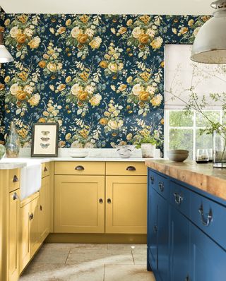 shaker kitchen with blue and yellow cabinets and patterned floral wallpaper