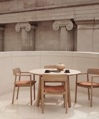 Benchmark wooden dining chairs with wooden table in museum setting