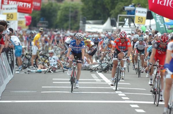 Riders, including Fabian Cancellara (Saxo Bank) cross the line after surviving a mass crash in the final sprint.