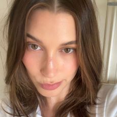 Hailey Bieber taking a selfie with glowing skin