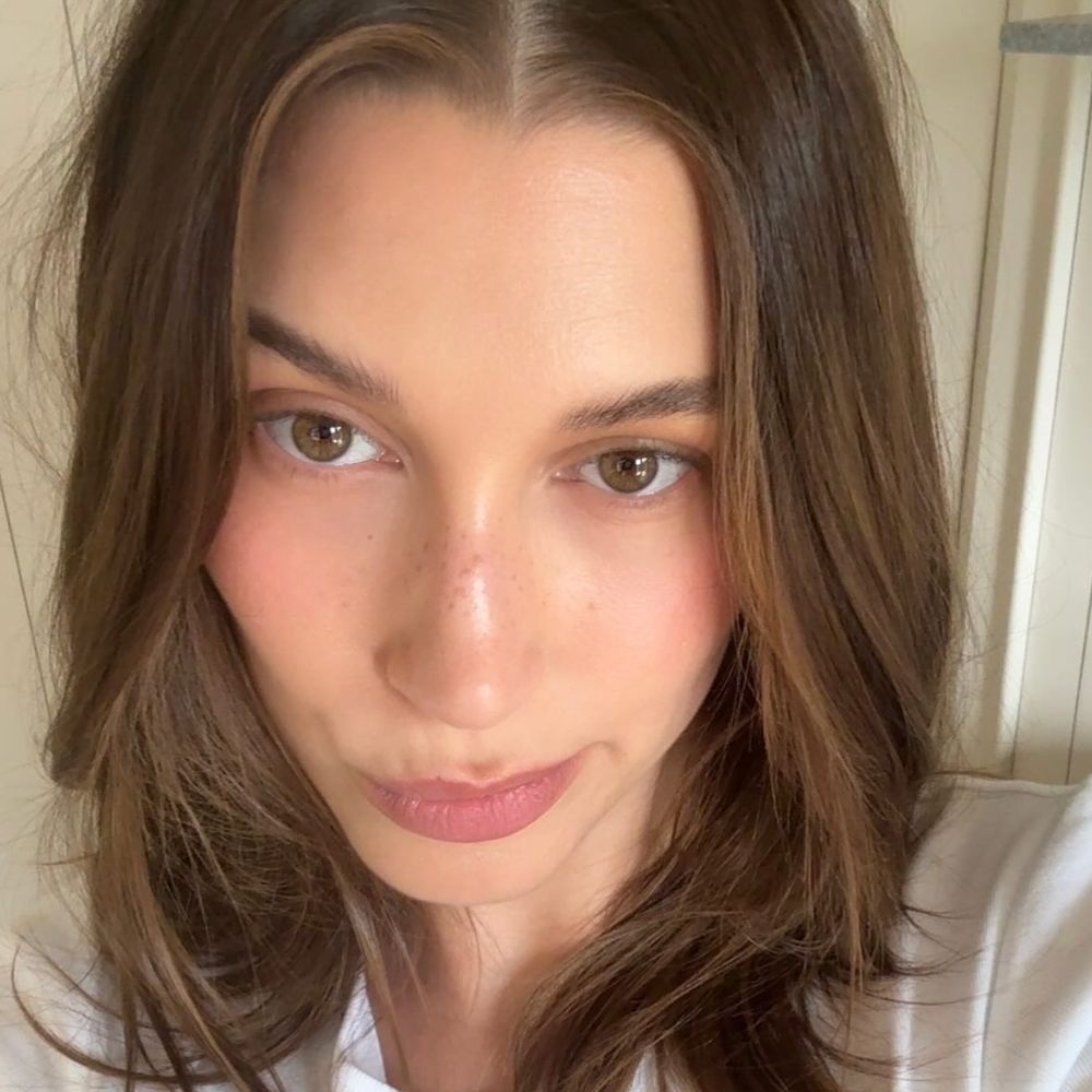 Hailey Bieber taking a selfie with glowing skin