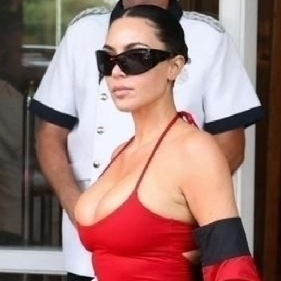 Kim Kardashian styled baggy cargo pants with socks and flip flops 