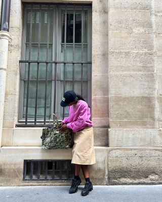 Fashion influencer @aude_julie in Paris wearing a chic outfit with the controversial technical sneaker footwear trend.