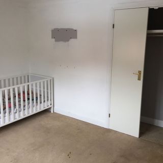 Before shot of an undecorated nursery with cot
