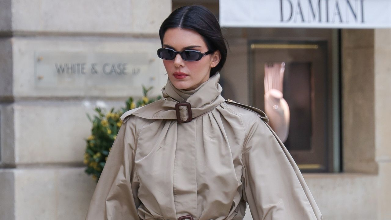 Kendall Jenner wearing a trench coat with an Hermes Kelly bag and jeans in New York City