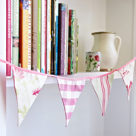 room with bunting flags and books in shelves